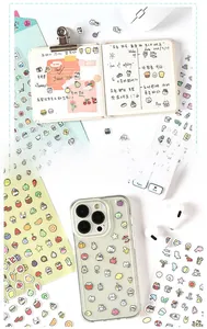 Close-up of cute cartoon stickers on a phone case and journal for DIY decoration