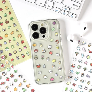 Transparent TPU phone case with cute cartoon cat and fruit stickers on a white desk
