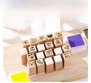 Close-up of wooden cartoon stamp set with rubber pads and colorful ink pads
