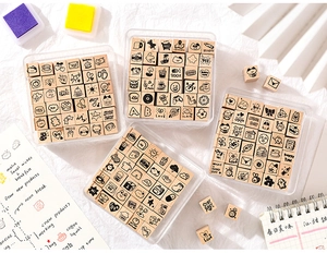 Detail of wooden stamp set with cartoon patterns and phrases for DIY journaling