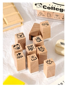 Detailed macro view of wooden stamps with cute cartoon patterns and hand-lettered text
