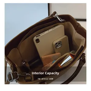 Detailed interior of a brown leather tote showing spacious compartments for gadgets