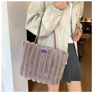 Detail of greyish-purple plush tote bag featuring ribbed faux fur and cherry patch