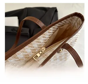 Detail shot of smooth gold-tone zipper and woven texture on this stylish tote bag