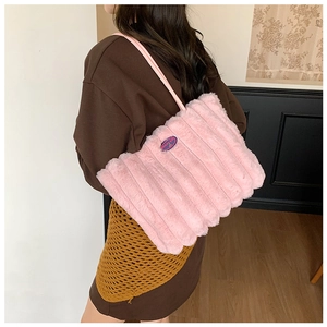 Detail of pink plush tote bag with vertical stripes and fashion embroidery patch