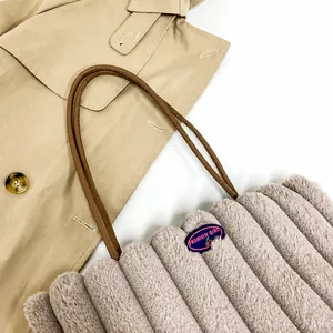 Detailed close-up of grey plush tote bag with quilted texture and fashion cherry patch