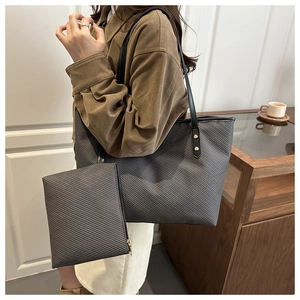 Detail of grey textured tote bag set with matching pouch and black shoulder strap