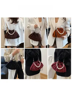 Detailed view of women's pleated drawstring bucket bags with pearl handles in various colors