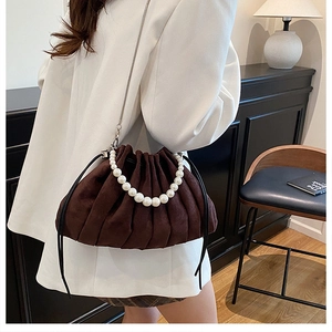 Brown suede drawstring bucket bag with pearl handle and silver chain strap details