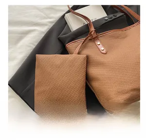 Caramel woven tote bag set with matching zipper pouch and vintage metal button detail