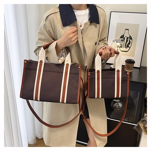 Comparison of large and small brown canvas tote bags with contrast straps and crossbody handles