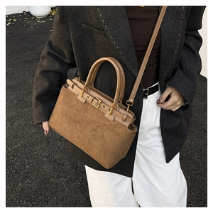 Retro brown suede tote bag featuring gold hardware and a classic buckle strap detail