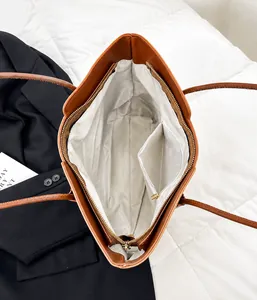 Top-down view of tote bag interior showing the main zip and inside pocket