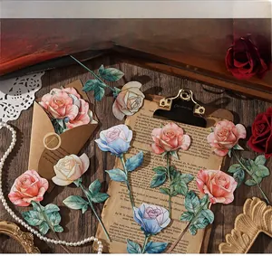 Close-up of vintage floral cards and kraft envelopes with artistic hand-painted textures