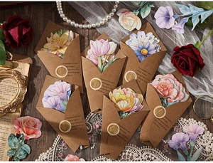 Detail of vintage floral card set in kraft envelope with gold wax seal and lace
