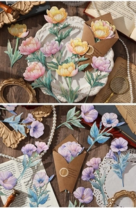 Detail of vintage floral card material with gold foil outlines and wax seal decor