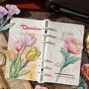Floral scrapbooking materials featuring vintage tulip and peony paper cutouts for DIY art