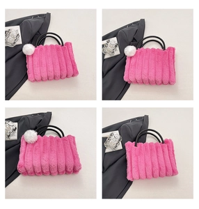 Detail view of pink plush tote with vertical stripes and black woven handles