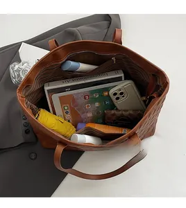 Detail view of brown large tote bag interior showing spacious capacity and quilted design