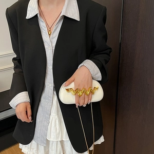 White minimalist acrylic handbag with gold wave handle and metal chain shoulder strap