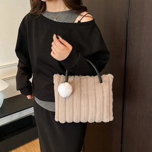 Fashionable plush striped tote bag in apricot with black handles and pompom detail