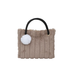 Brown plush striped tote bag with round black handles and a white faux fur keychain