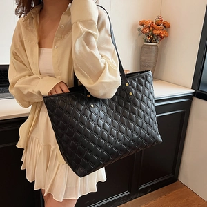 Quilted leather tote bag with gold rivets shown in a stylish lifestyle setting