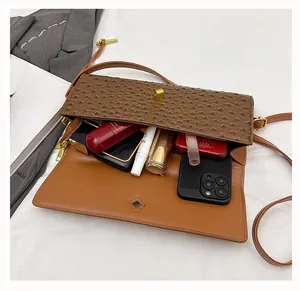 Detail view of the ostrich texture handbag interior showing spacious storage for essentials