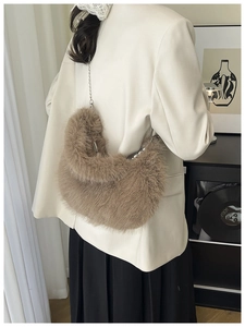 Brown faux fur crescent bag with elegant silver chain strap shown in lifestyle scene