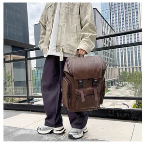 Detail view of a vintage brown PU leather backpack with multiple pockets and flip-top closure