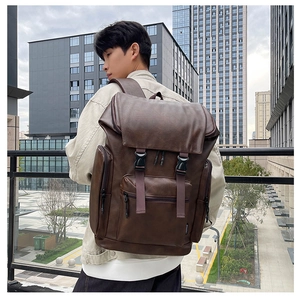 Close-up of dark brown PU leather backpack texture and side pocket with Fashion label