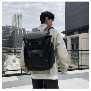Macro shot of waterproof black PU leather backpack showing side buckle and fashion label