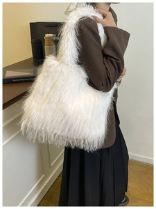 Lifestyle shot of white faux fur tote bag with plush texture on a model in a cafe