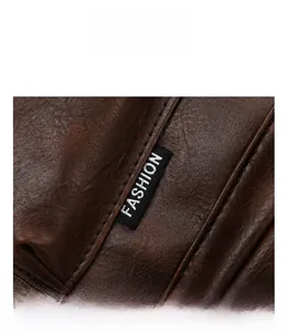 Detail view of dark brown faux leather backpack with litchi texture and fashion woven label