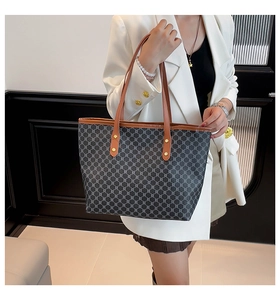 Detail shot of the vintage monogram tote bag with brown leather trim and gold studs