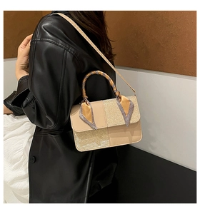 Detail of a chic patchwork crossbody bag with scarf-wrapped handle on a model's shoulder