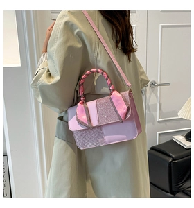 Detail of pink sequin texture handbag with silk scarf handle on beige trench coat