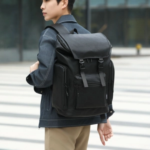 Black leather backpack for men with multi-pocket flap design for outdoor travel use