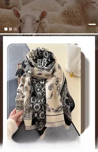 Detail of soft long scarf featuring vintage black and beige paisley patterns with tassels