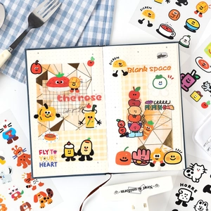 Creative PET cartoon food stickers and cute animal decals on a navy blue journal cover