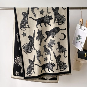Detailed view of the woven fringe edge and vintage black cat pattern on the shawl
