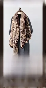 Close-up of winter scarf with floral pattern showing thick imitation cashmere fabric