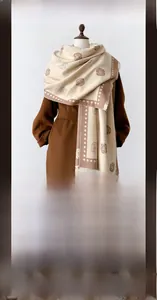 Detail of warm winter cashmere-like scarf with rose floral patterns and dot borders