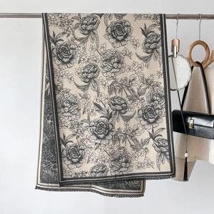 Elegant cashmere-feel scarf with black floral peony pattern and tassel fringe detail