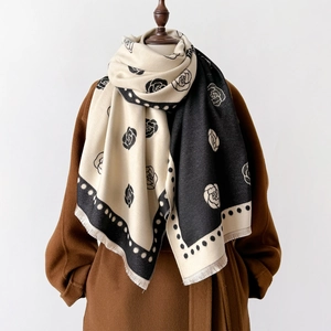Close-up of camellia floral print scarf with polka dot borders and tassel fringes