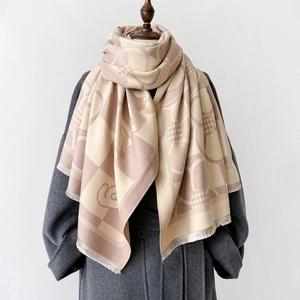 Dual-sided plaid shawl with tassels on a mannequin over a stylish wool coat