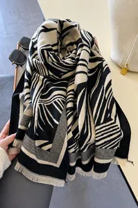 Detail of soft zebra stripe scarf with fringe tassels and high-density warm texture