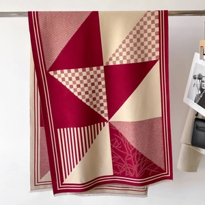 Classic red plaid scarf with modern geometric knit patterns and delicate fringe detailing