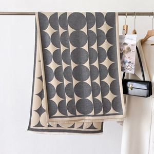 Minimalist geometric scarf in grey and beige with large dots and fringe detail
