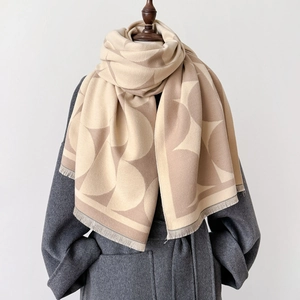 Elegant geometric shawl with fringe, beige and brown half-circle pattern on grey coat